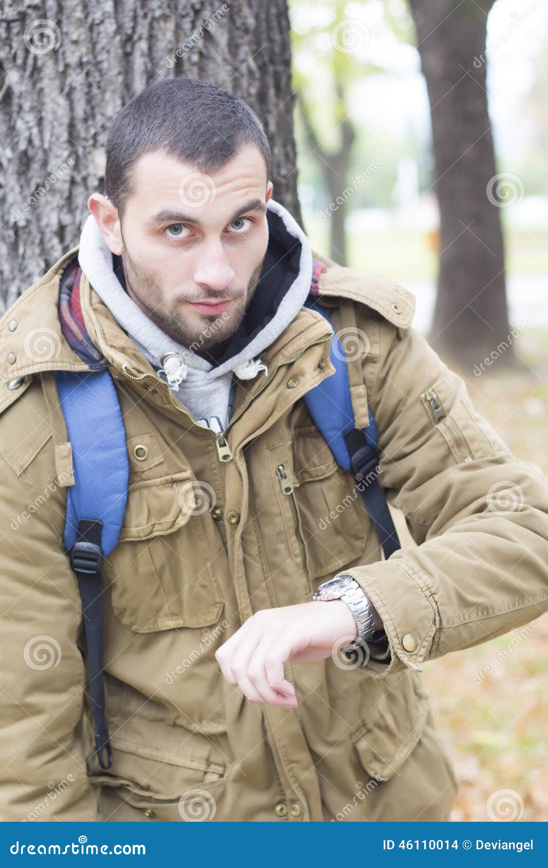 Young Men Watching His Clock Stock Photo Image of clock, green 46110014