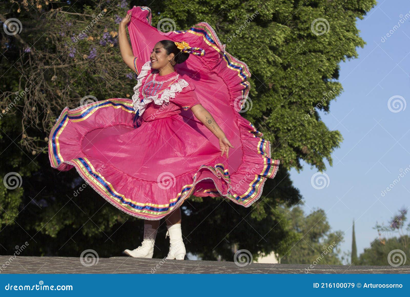 a young mexican woman folk dancer with traditional costume