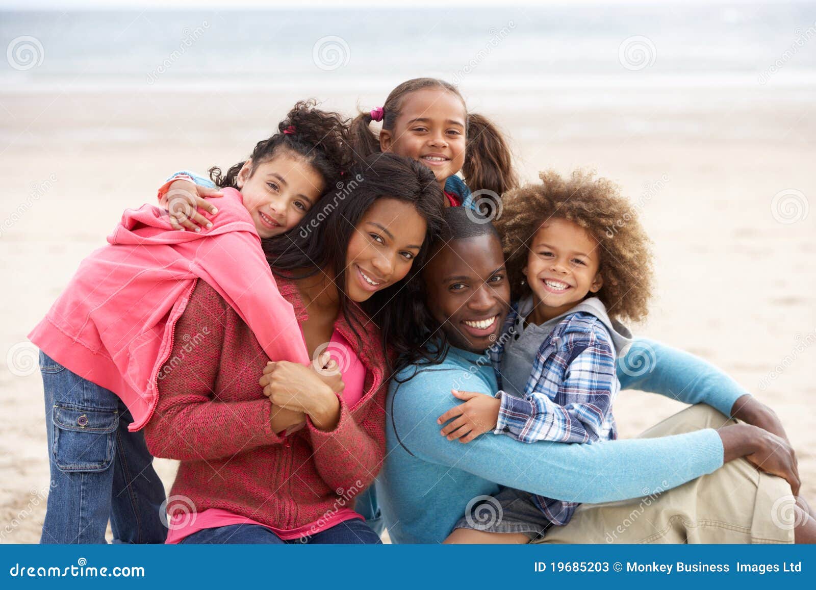 Young Mixed Race Family Embracing on Beach Stock Image Image of