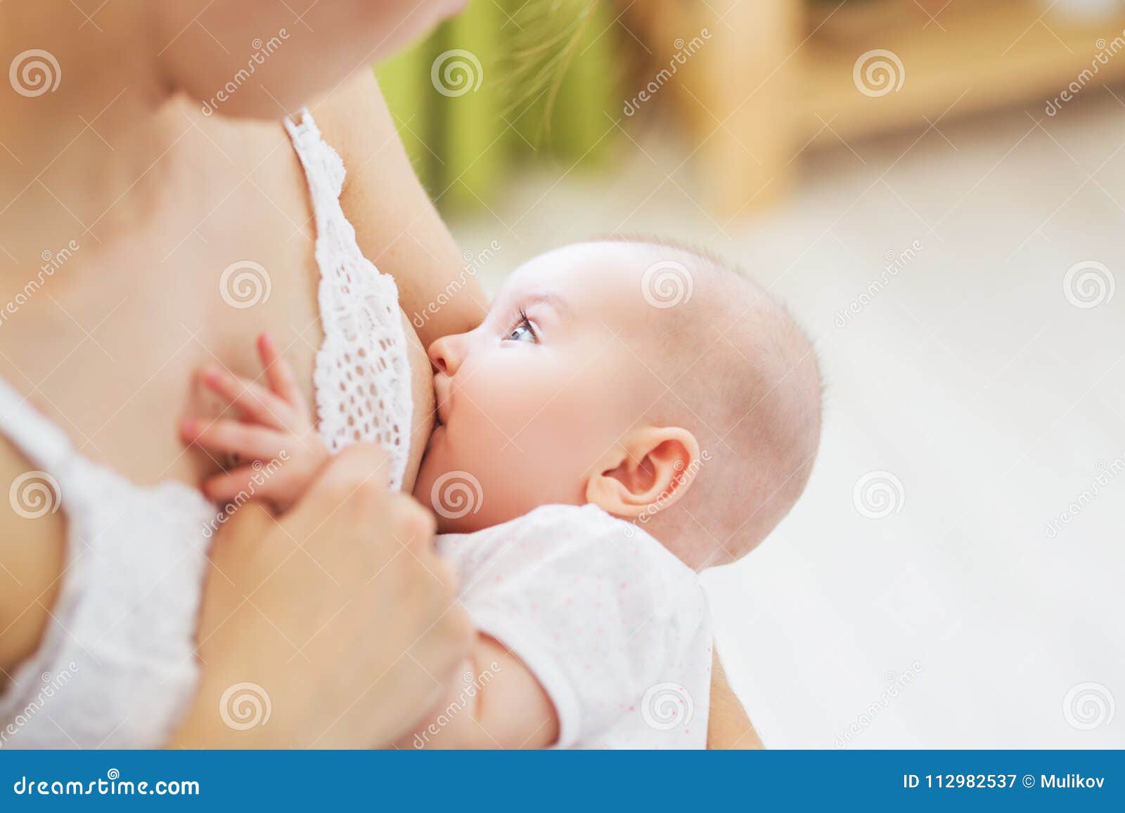 young mom breast feeding her newborn child. lactation infant concept. mother feed her baby son or daughter with breast milk