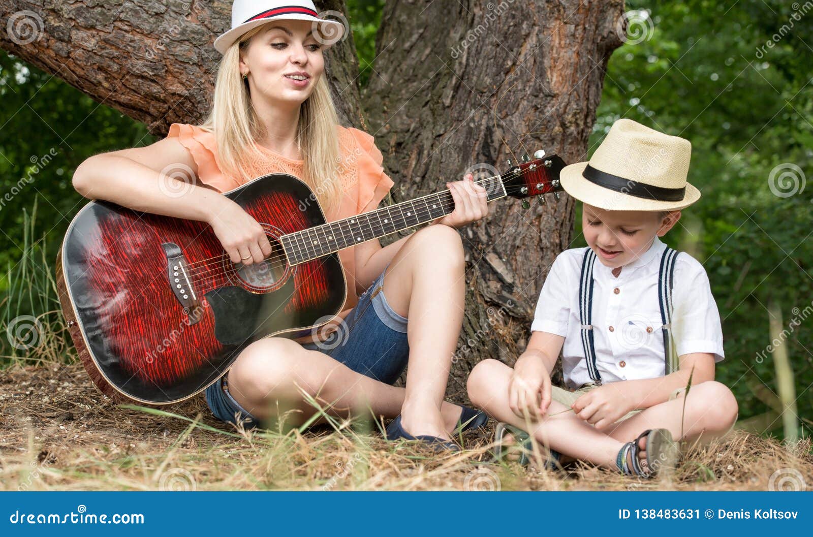 Young Mother and Beautiful Son Rest in the Forest,sing Songs Under a ...