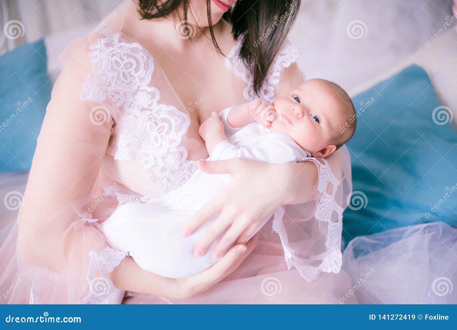 Young Mother In A Boudoir Dress With A Baby In Her Arms By The Canopy Bed Stock Image Image Of Beautiful Family