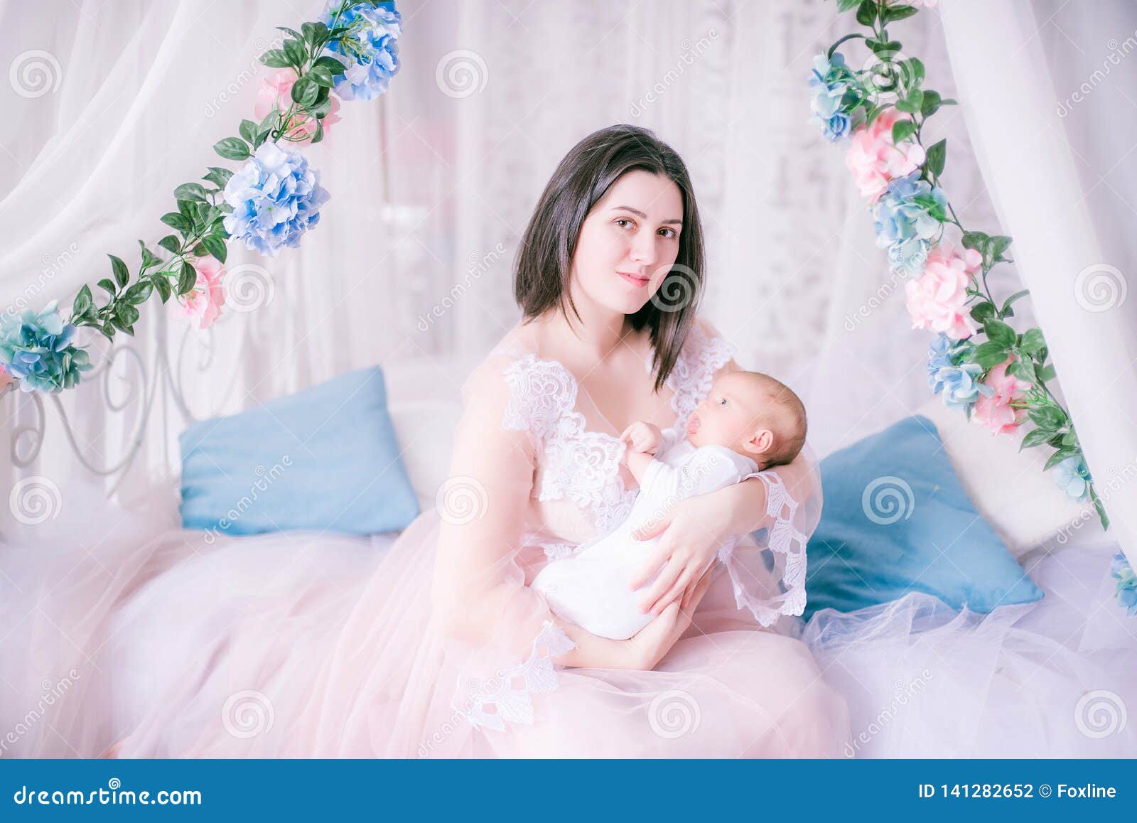 Young Mother In A Boudoir Dress With A Baby In Her Arms By The Canopy Bed Stock Photo Image Of Beauty Beautiful