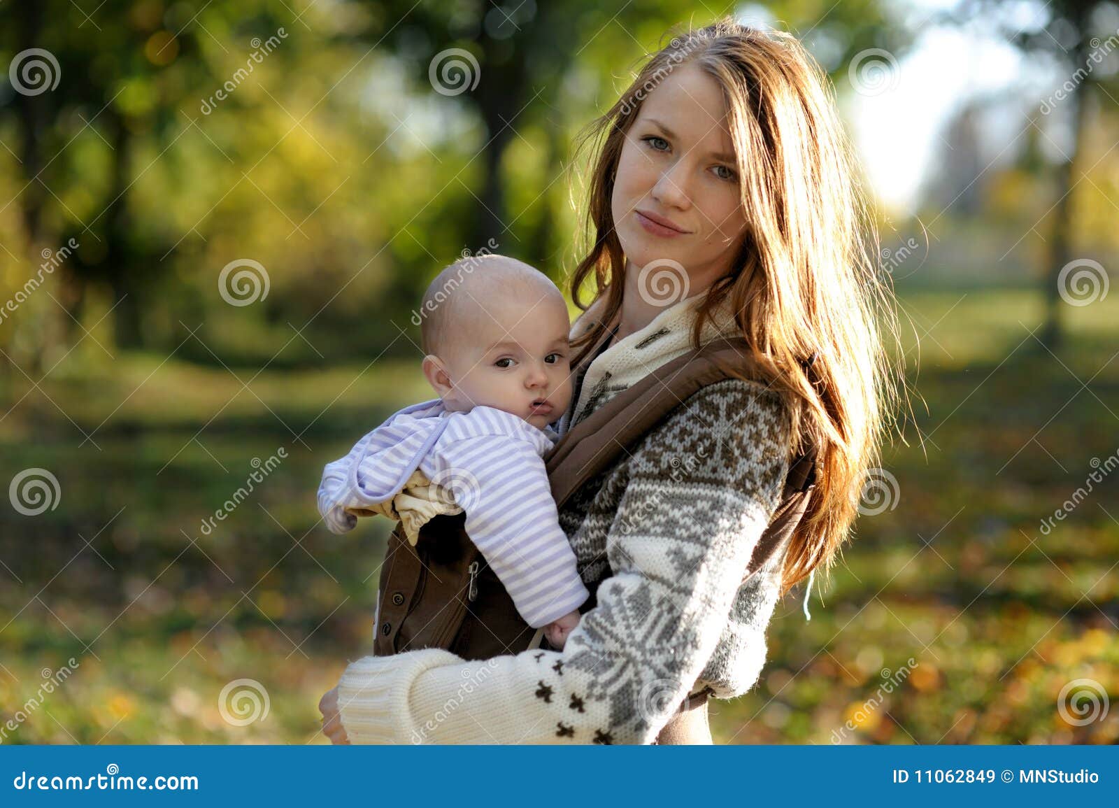 young mother with her baby in a carrier