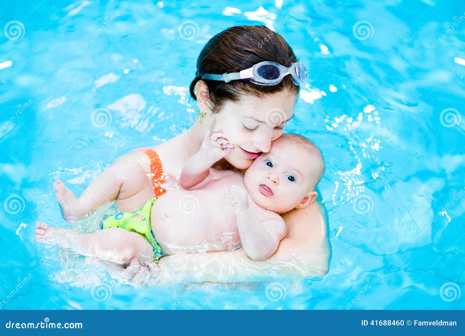 young mother and her little baby in swimming poo