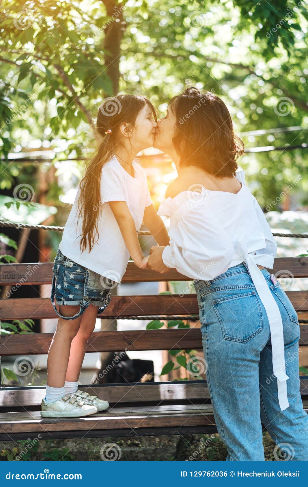 Download Young Mother Hugging Her Little Girl In The Park Stock Photo - Image of keep, outdoors: 129762036
