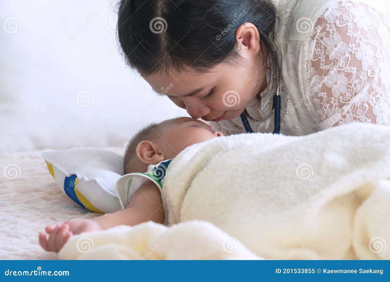 Young Mother Kiss Her Cute Little Baby Face With Love While Her Son