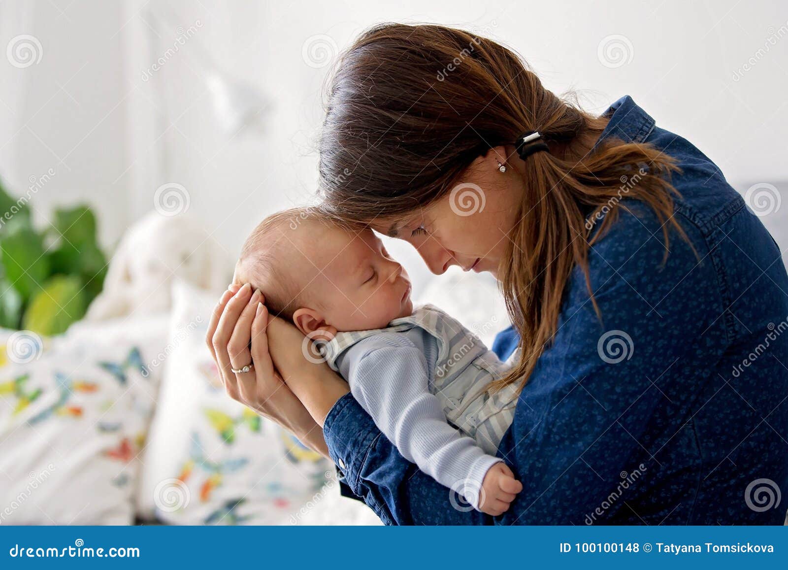 Young Mother, Kissing Her Newborn Baby Boy at Home Stock Photo ...