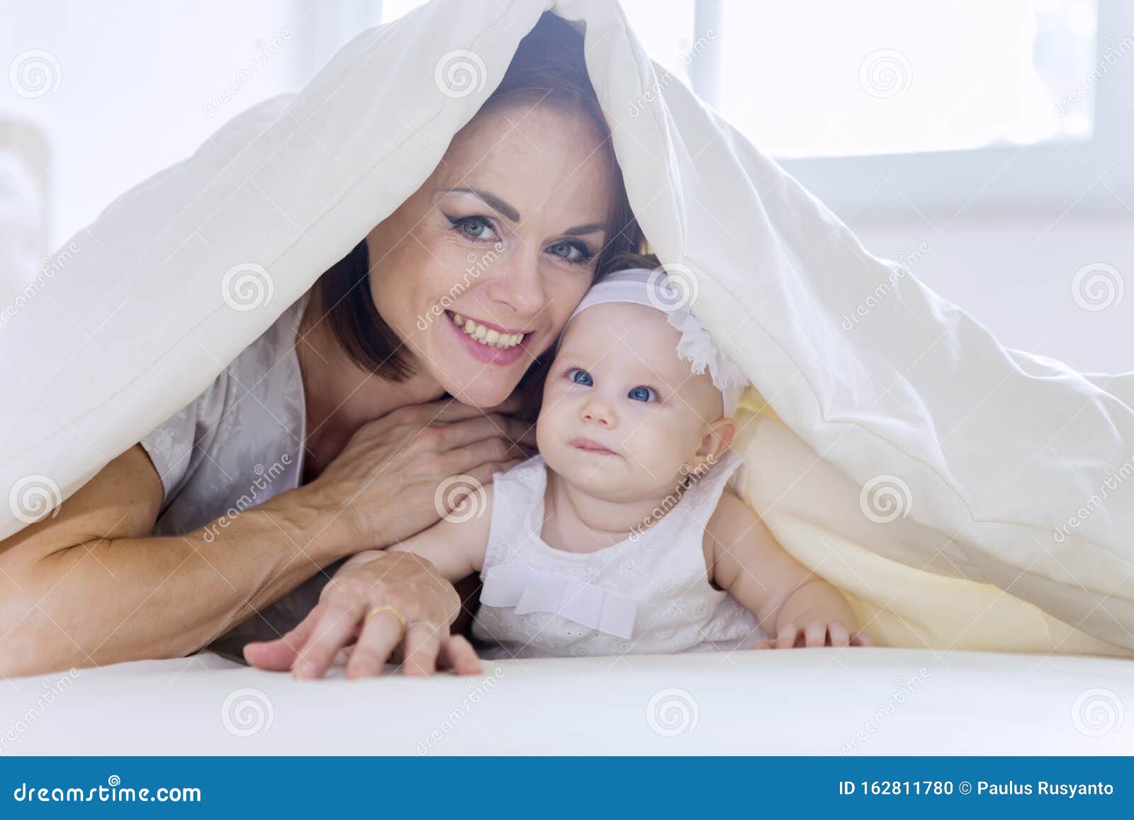 Young Mother Plays with Her Baby Under a Blanket Stock Photo - Image of ...