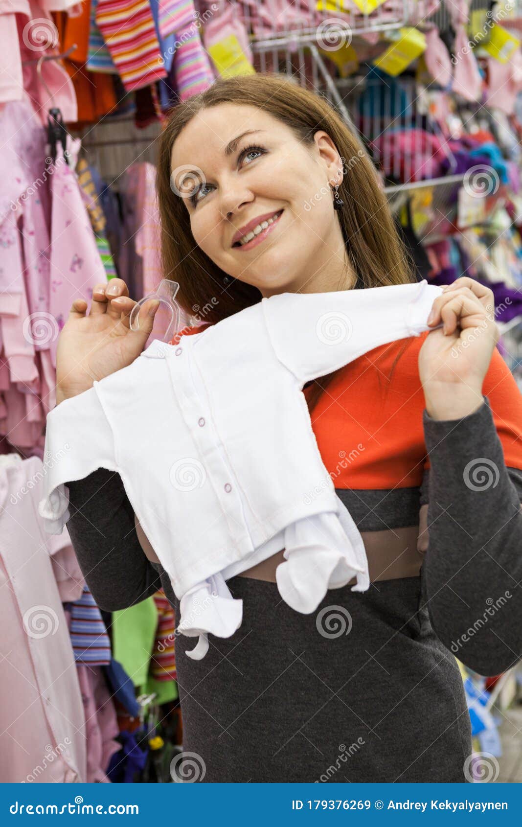 Young Mother is Touched of Small Baby Bodysuit while Choosing Infant ...