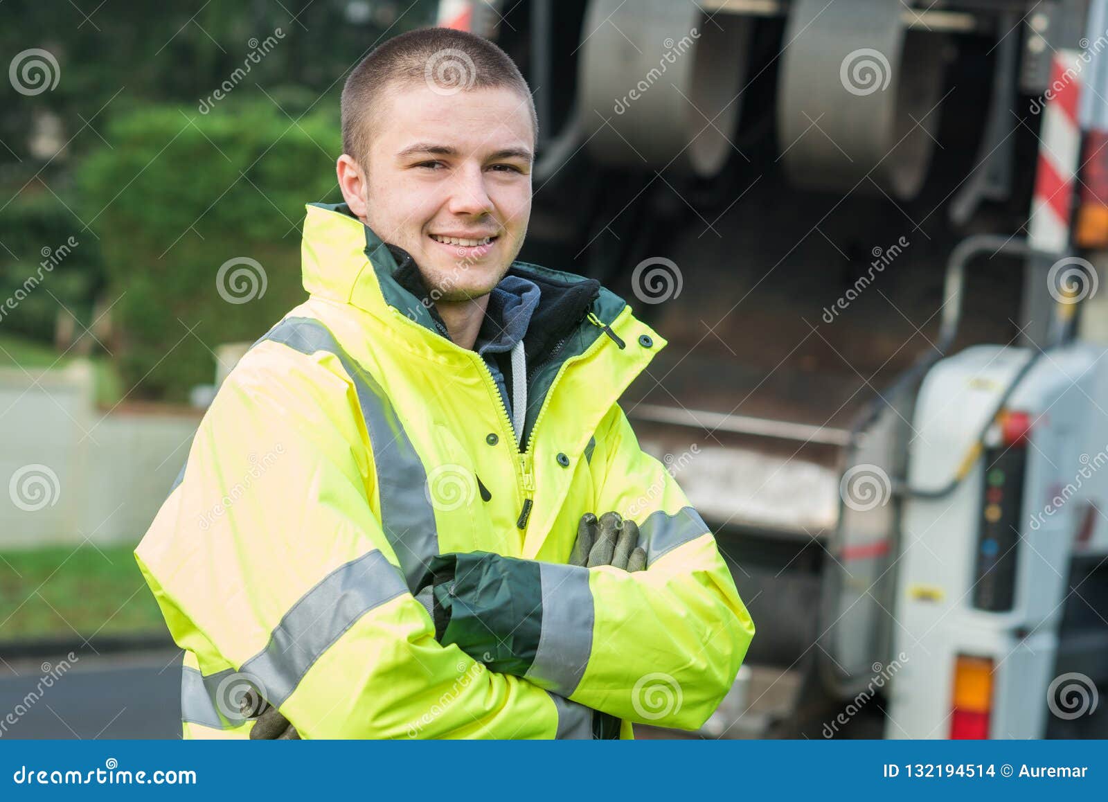 young municipal garbage collector near garbage truck