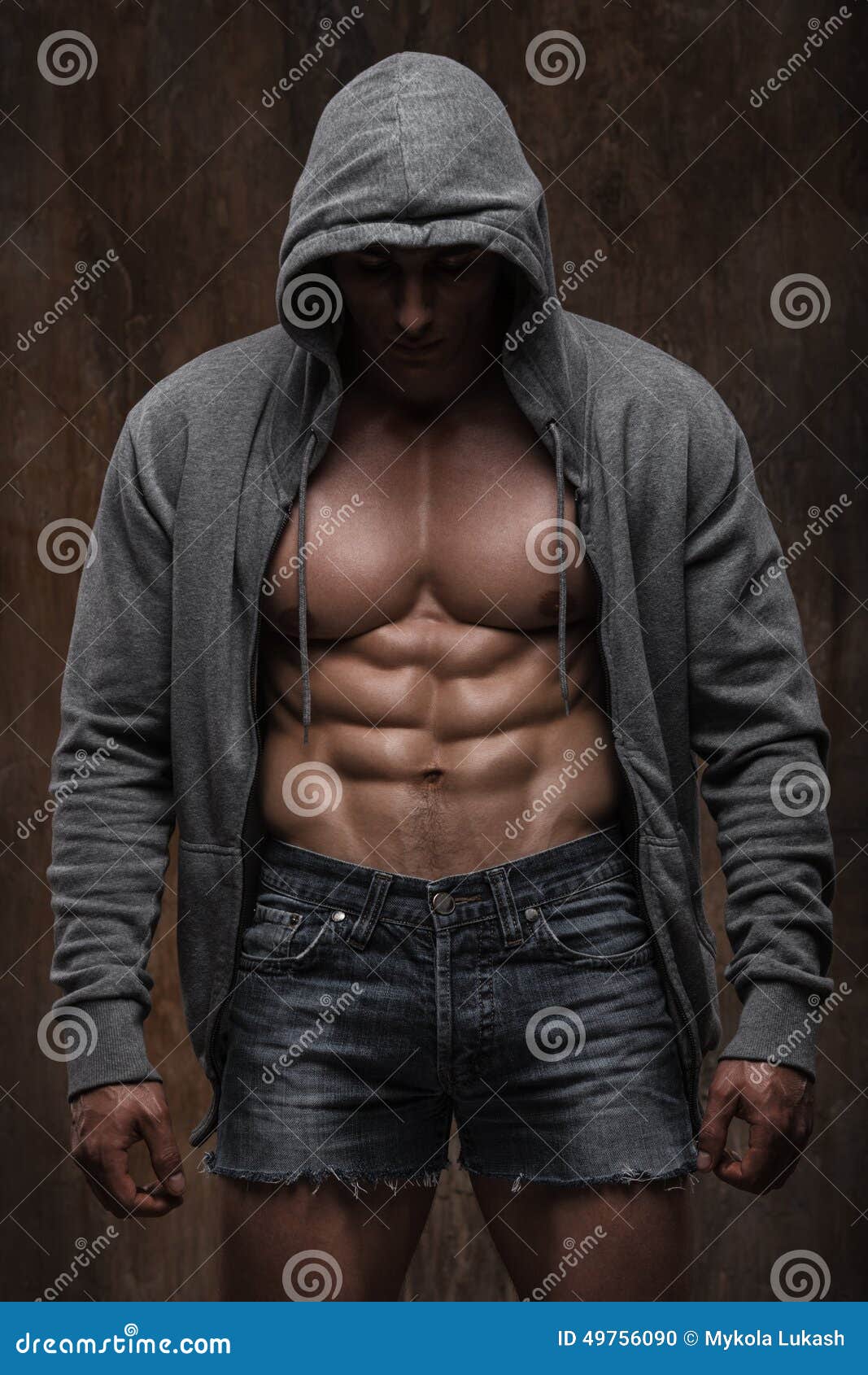 young muscular man with open jacket revealing muscular chest and abs