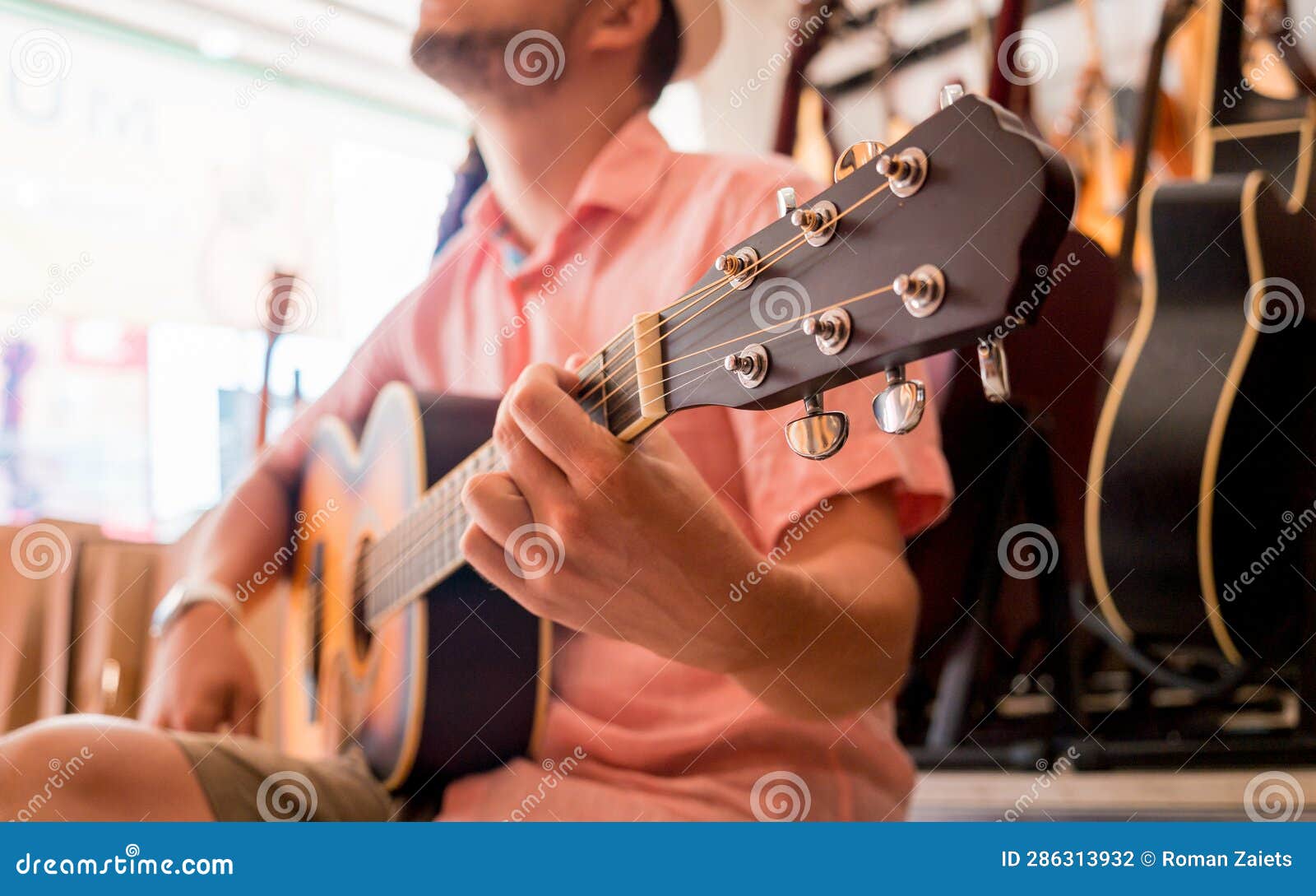Young Musician Testing Classical Guitar in a Guitar Shop Stock Photo