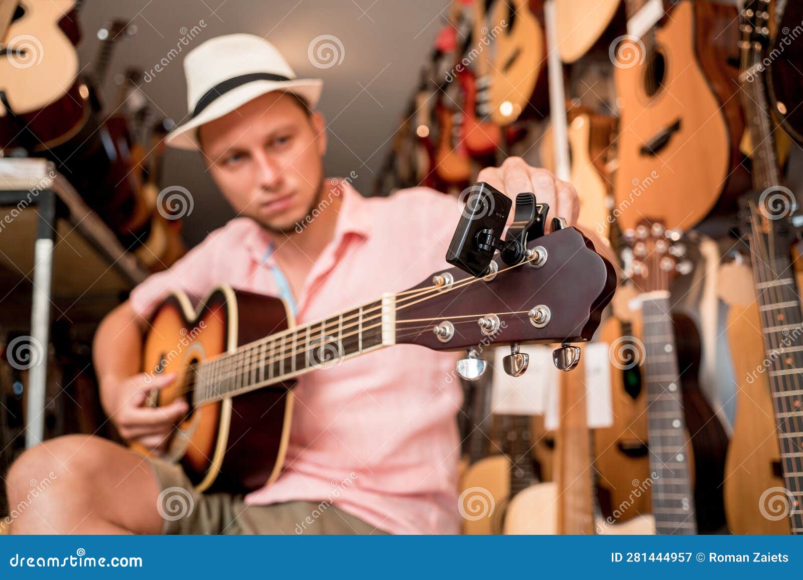 Young Musician Tuning a Classical Guitar in a Guitar Shop Stock Image