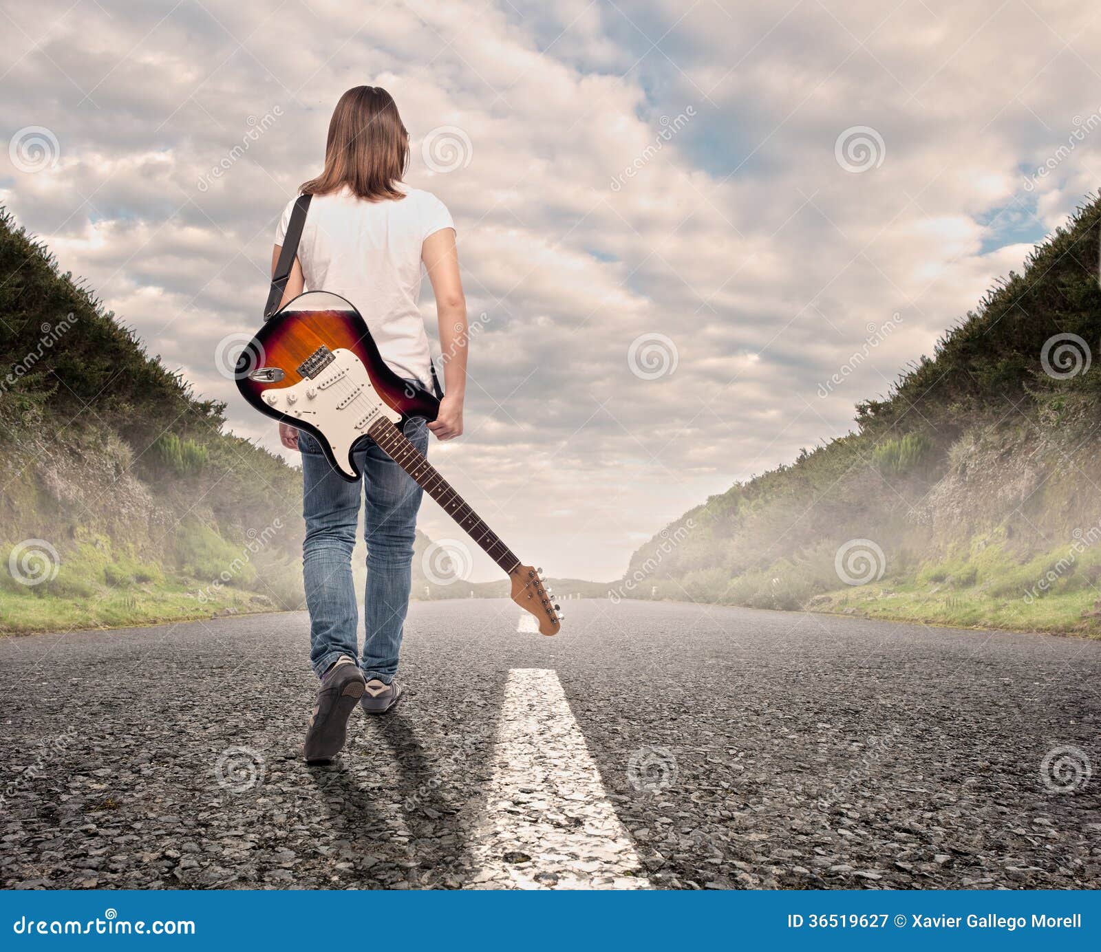 young musician woman walking on a road