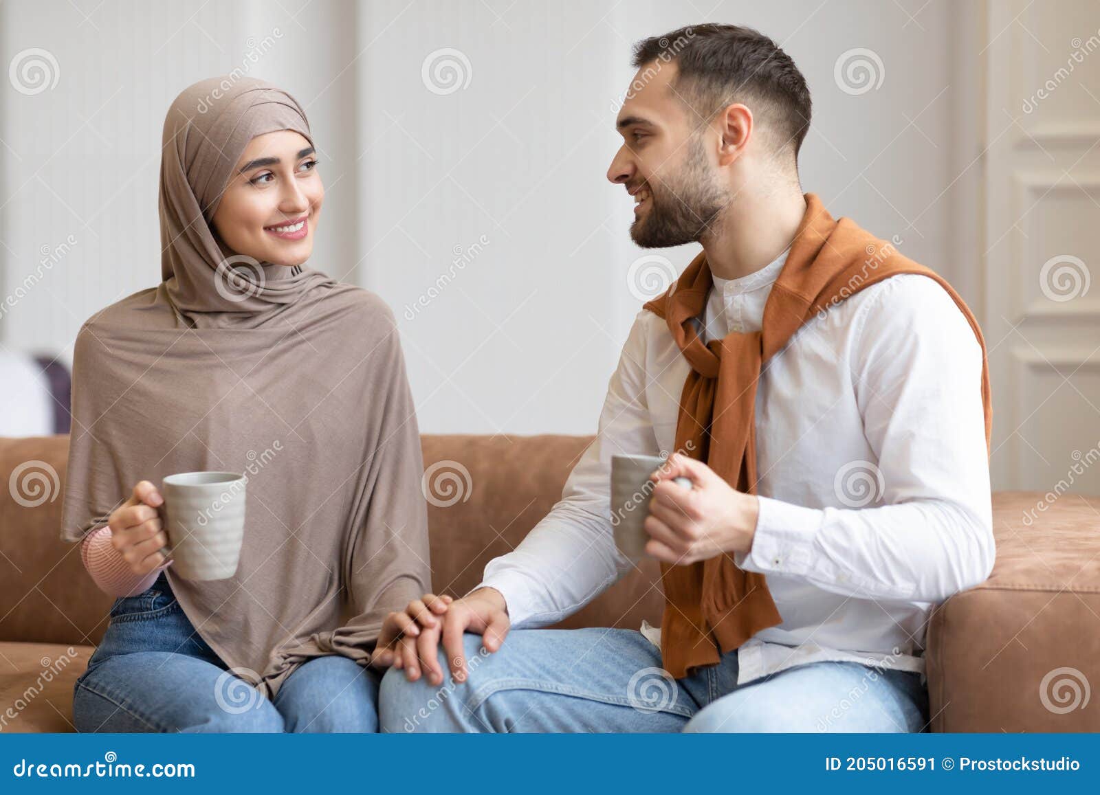 Young Muslim Couple Talking and Flirting Drinking Coffee at Home ...