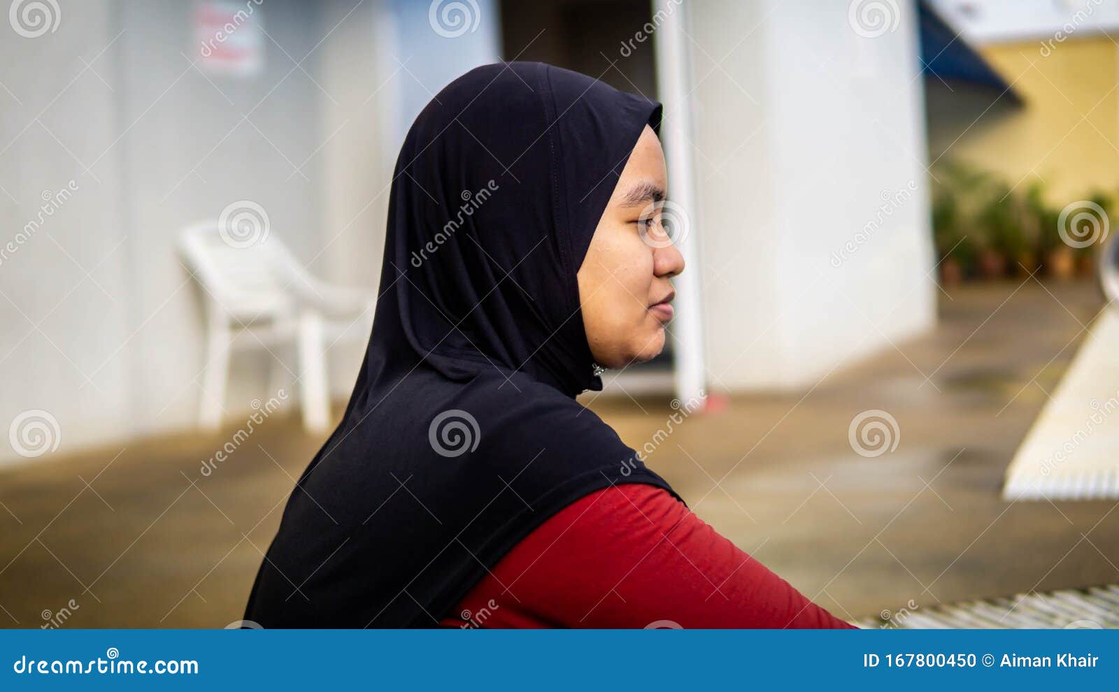 Young Muslim Malay Girl With Hijab Sitting At The Stairs At The