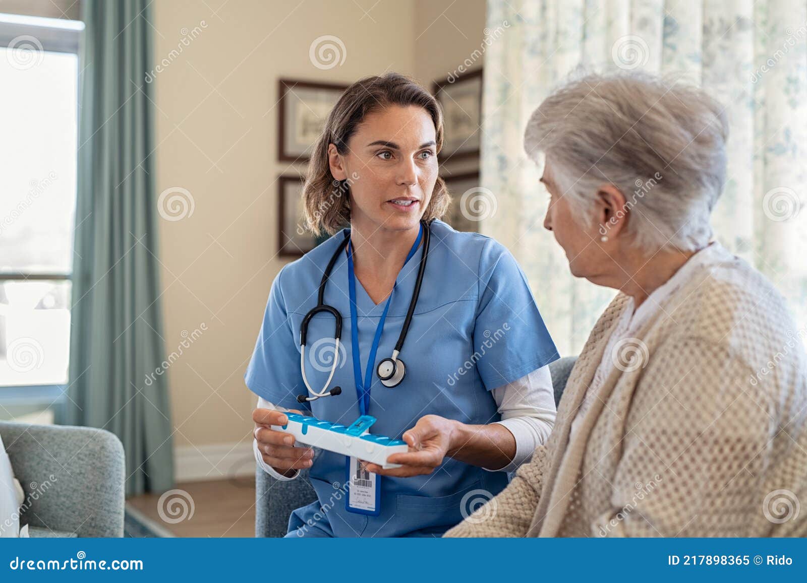 nurse explaining medicine dosage to senior woman at nursing home