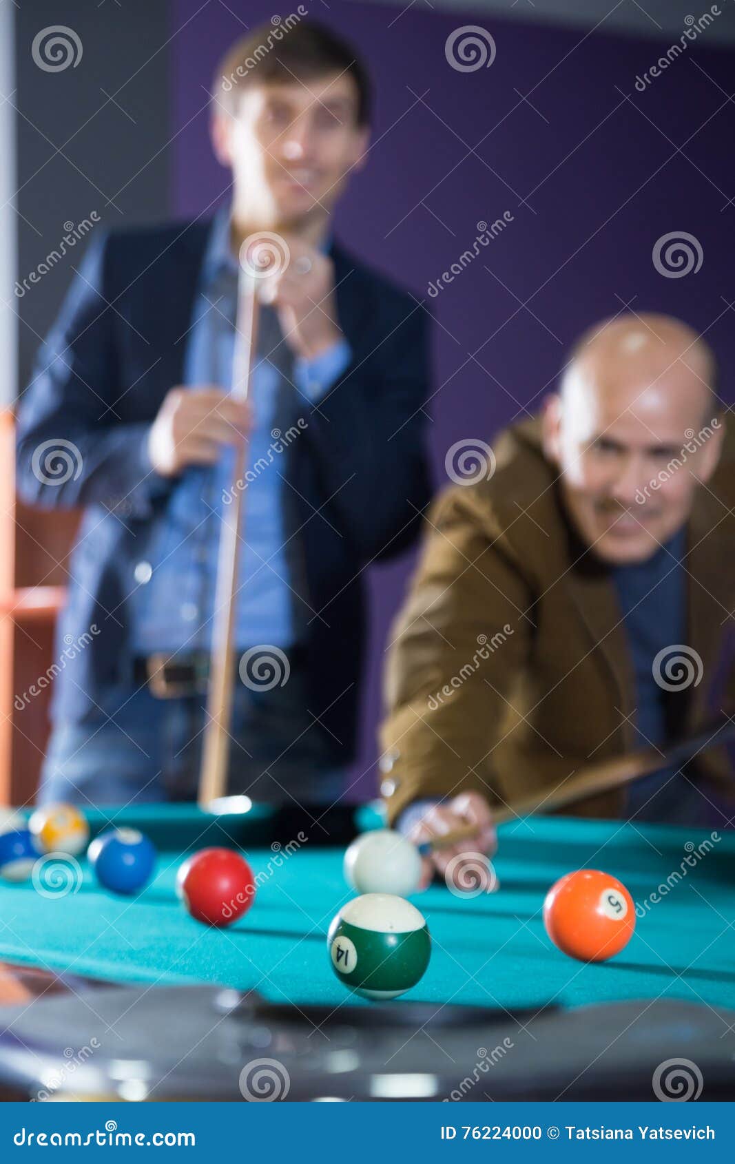 Young and the Old Man Enthusiastically Playing Billiards Stock Photo