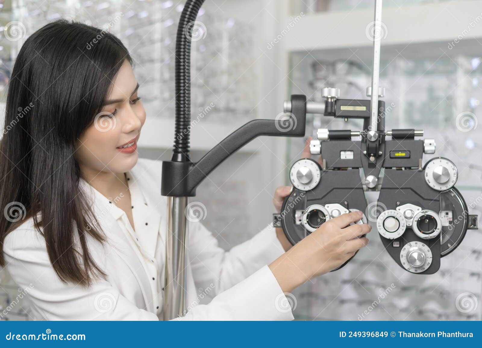 young ophthalmologist doing visual test for customer using bifocal optometry eyesight measurement device in optical center,