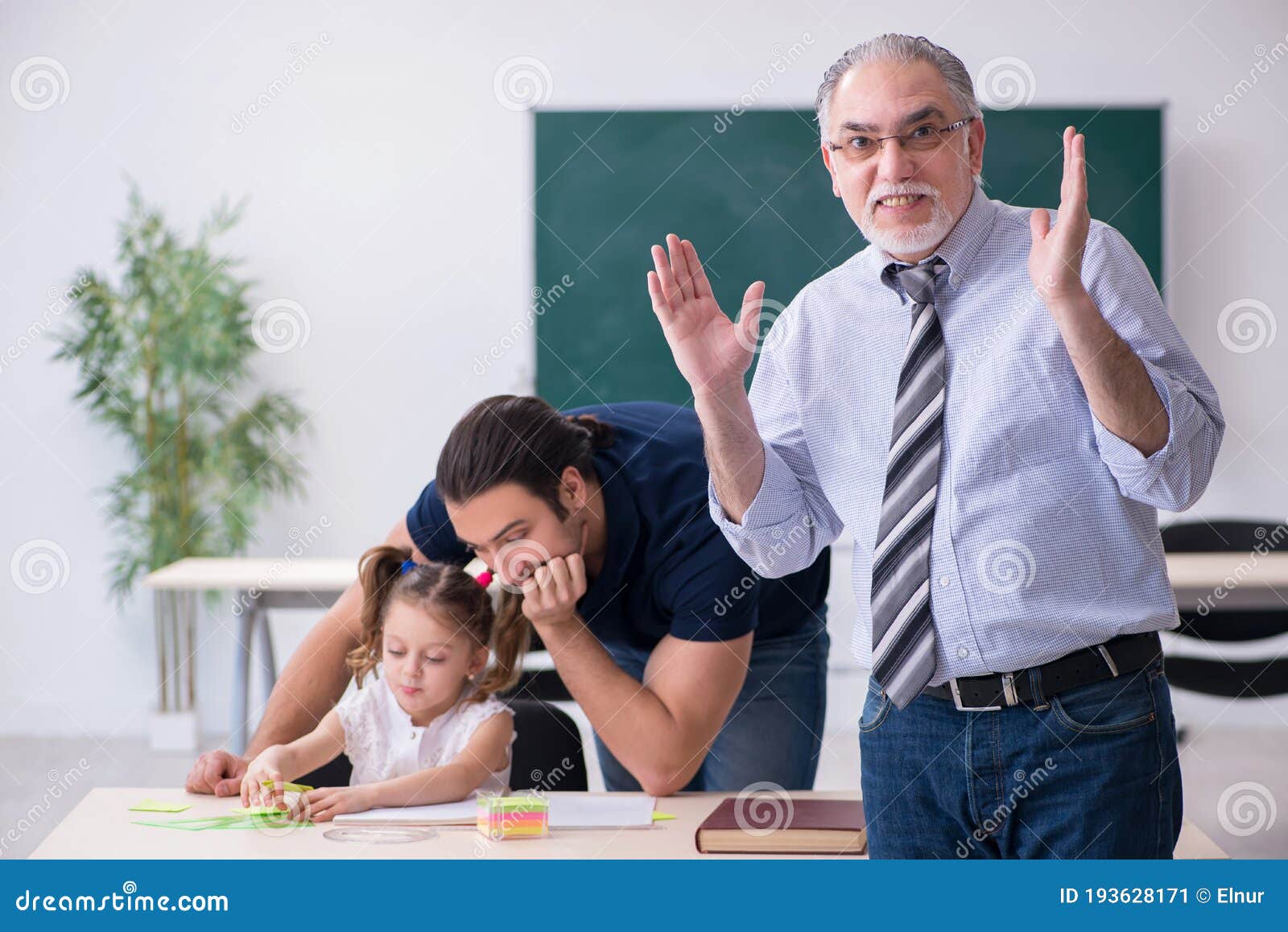Young Parent Old Male Teacher And Little Girl In The Classroom Stock