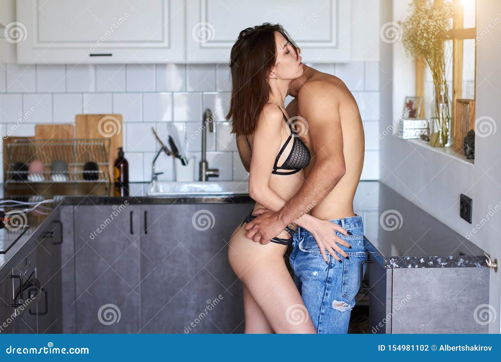 Young Passionate Couple Having Sex in the Kitchen Stock Photo