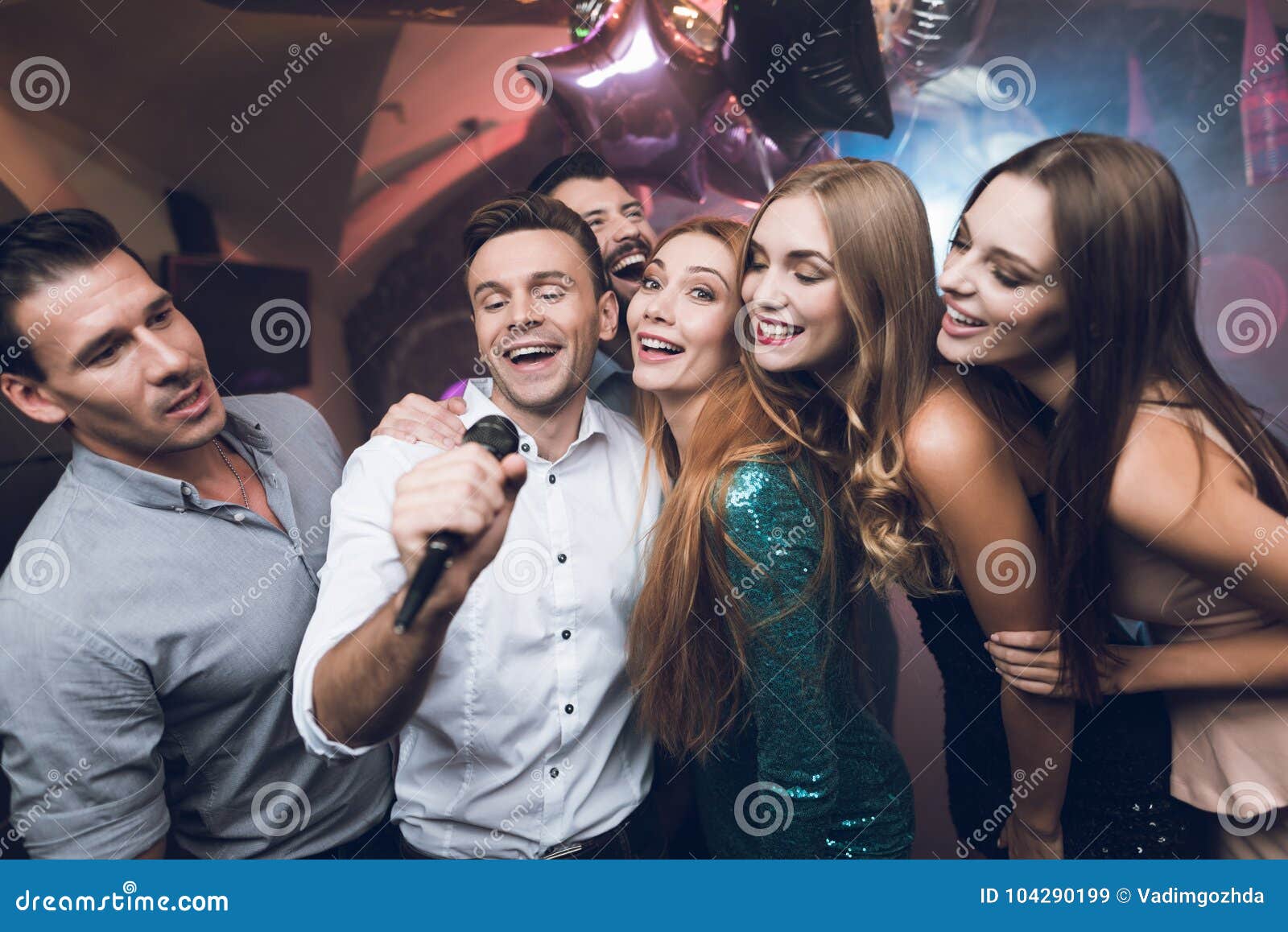 Young People in the Club Dance and Sing. a Man in a White Shirt is ...