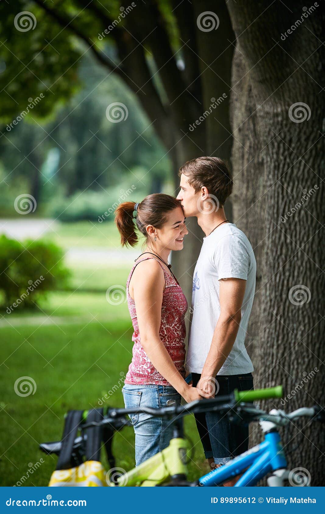 Young People Couple With Bicycles In The Park Stock Ph