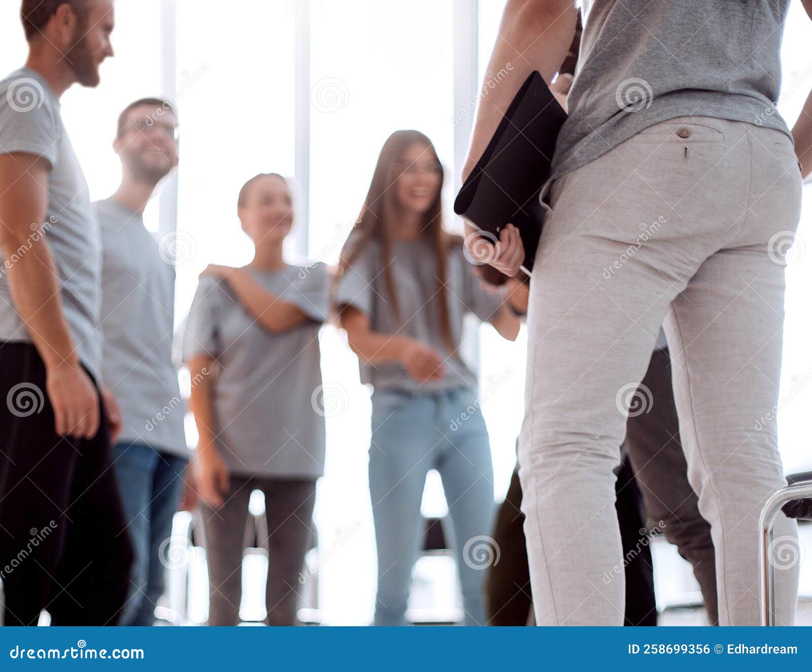 Young People Greet Each Other in the Conference Room Stock Photo Young People Greet Each Other in the Conference Room Stock Photo