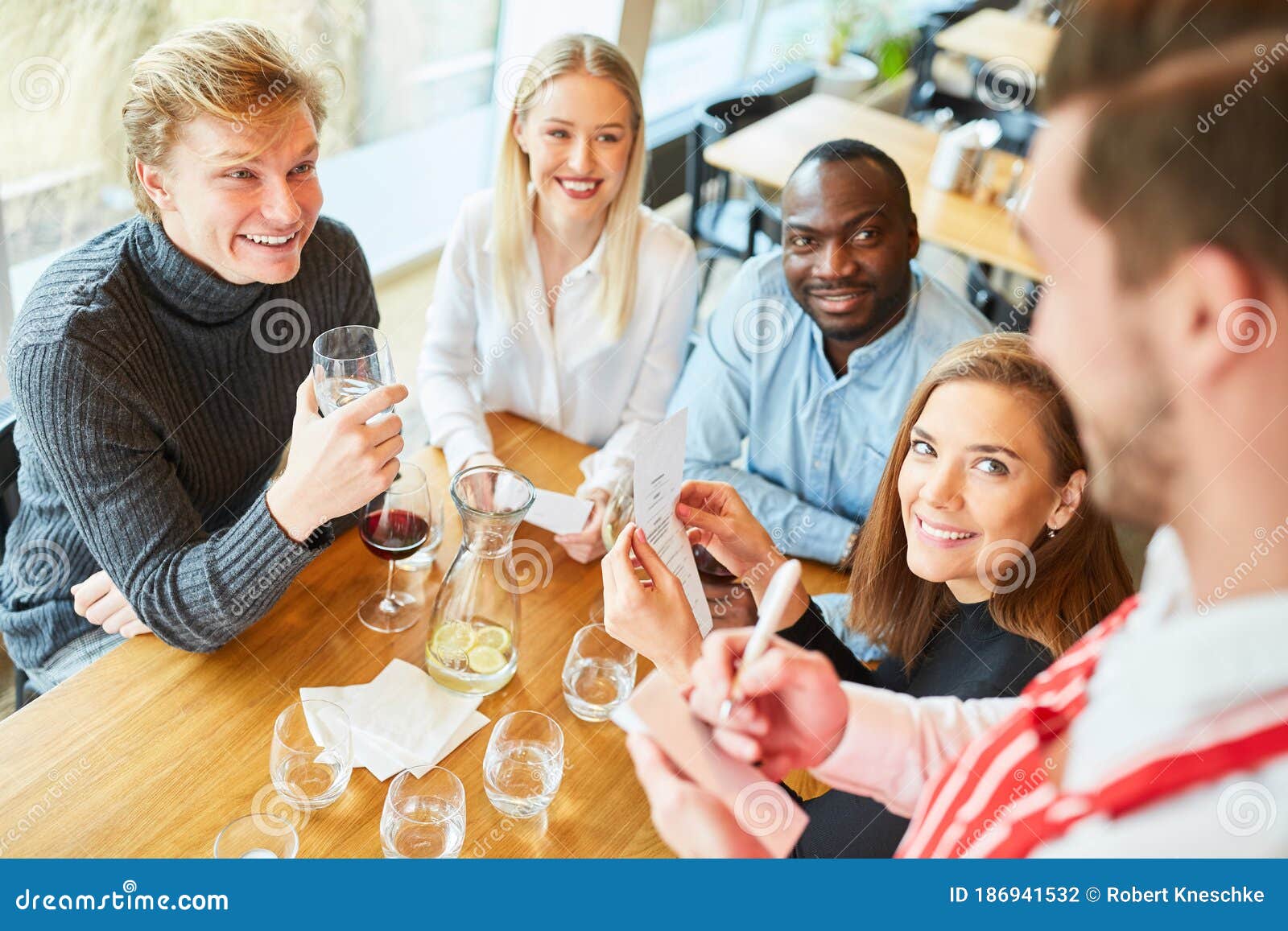Young People Order Food from a Waiter Stock Photo - Image of food