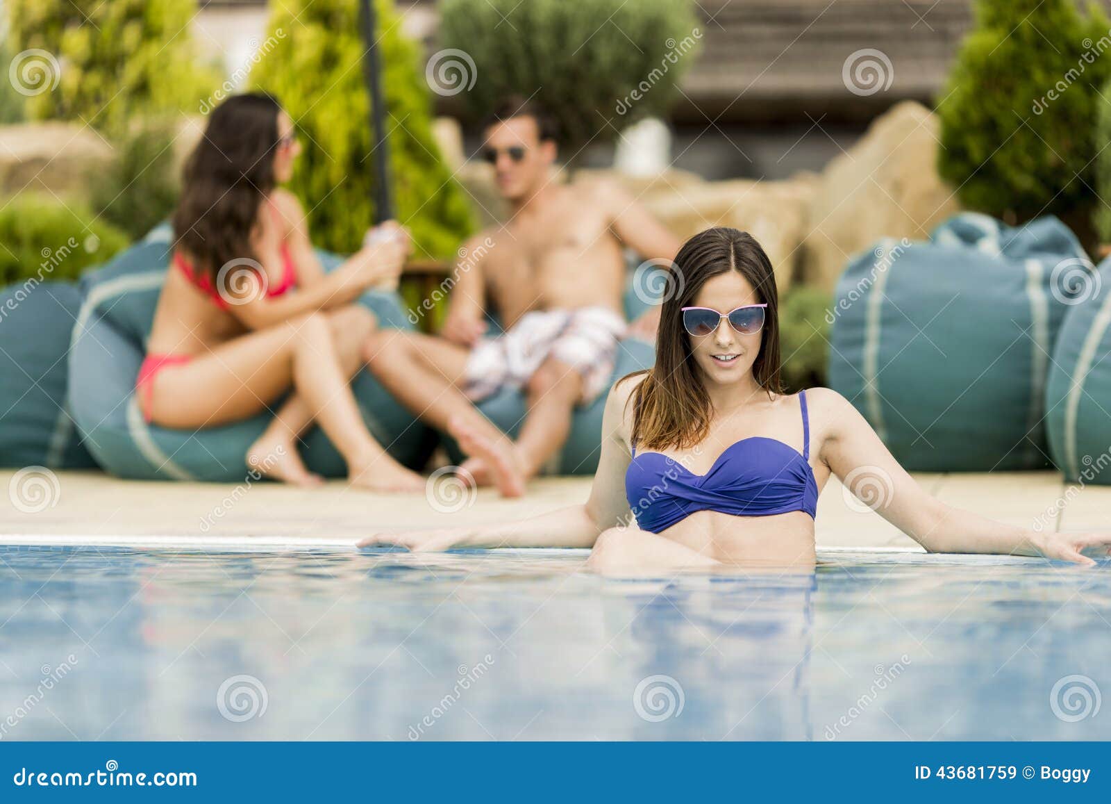 Young people by the pool. Young people by the swimming pool