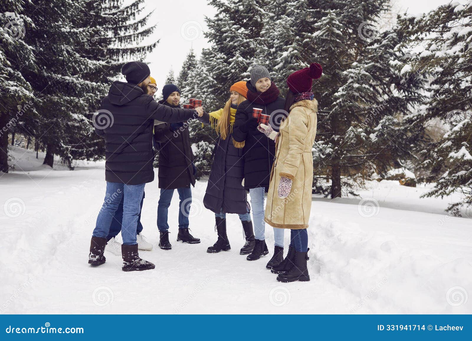 young people relax together in park drinking warm tea