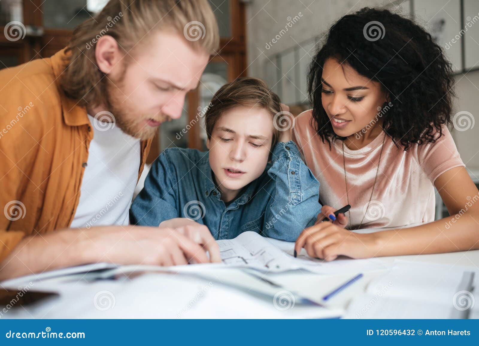 Young People Thoughtfully Discussing Something In Office