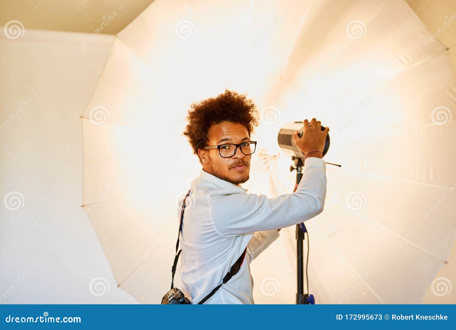 Young Photographer with Studio Light and Flash Light Stock Image