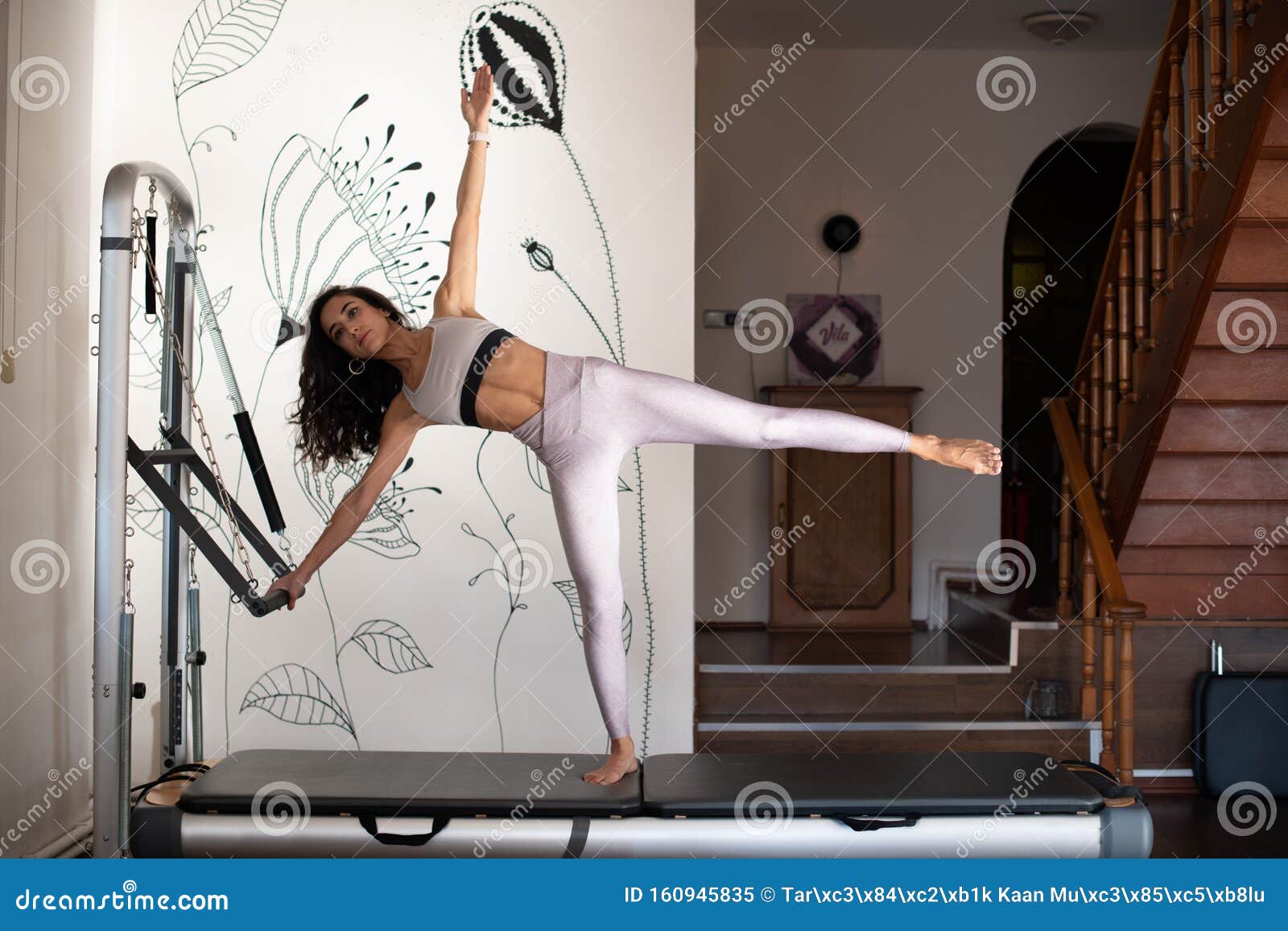 Young Pilates Instructor Woman Exercising on Pilates Reformer. Using a Pilates Ring Stock Image