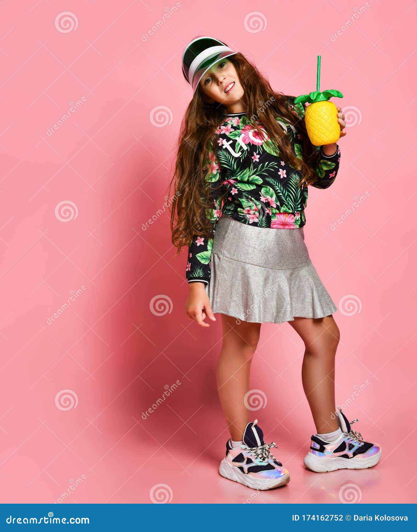 Young Plus Girl Model in Stylish Floral Printed Casual Clothing, Sneakers and Cap Standing and Holding Healthy Diet - Image of fashion, detox: 174162752