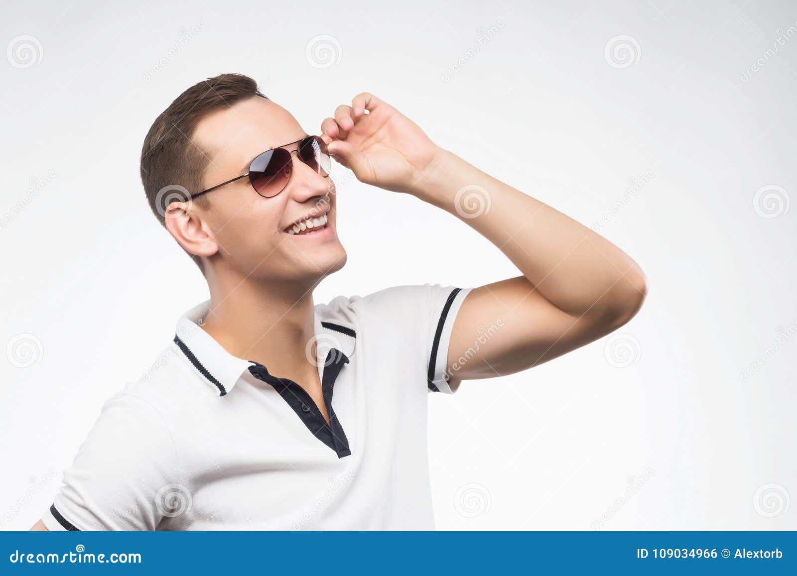 A Young Positive Man in Sunglasses, Lit by Warm Sunlight. Emotional ...