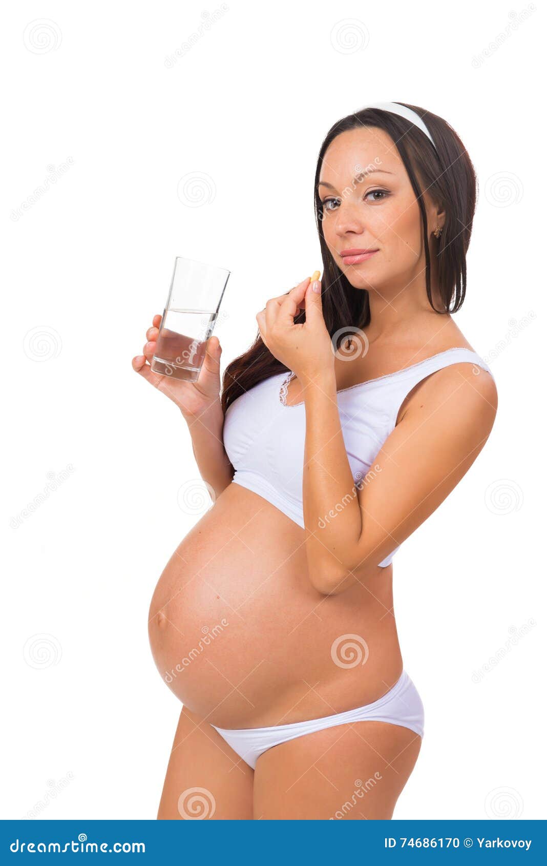 Young Pregnant Woman Taking A Pill, Prenatal Vitamins ...