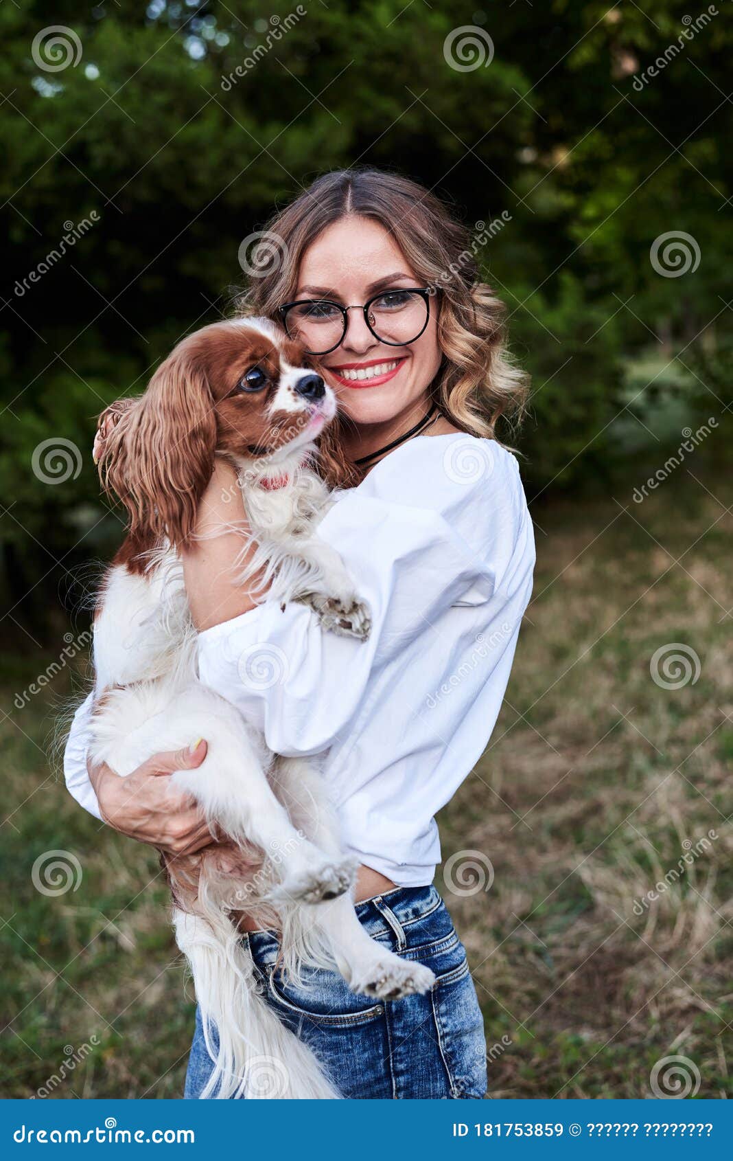 Young Pretty Blond Woman with Curly Hair, Wearing Eyeglasses and White  Shirt, Holding Small White and Brown Dog in Park in Summer Stock Image -  Image of picnic, green: 181753859