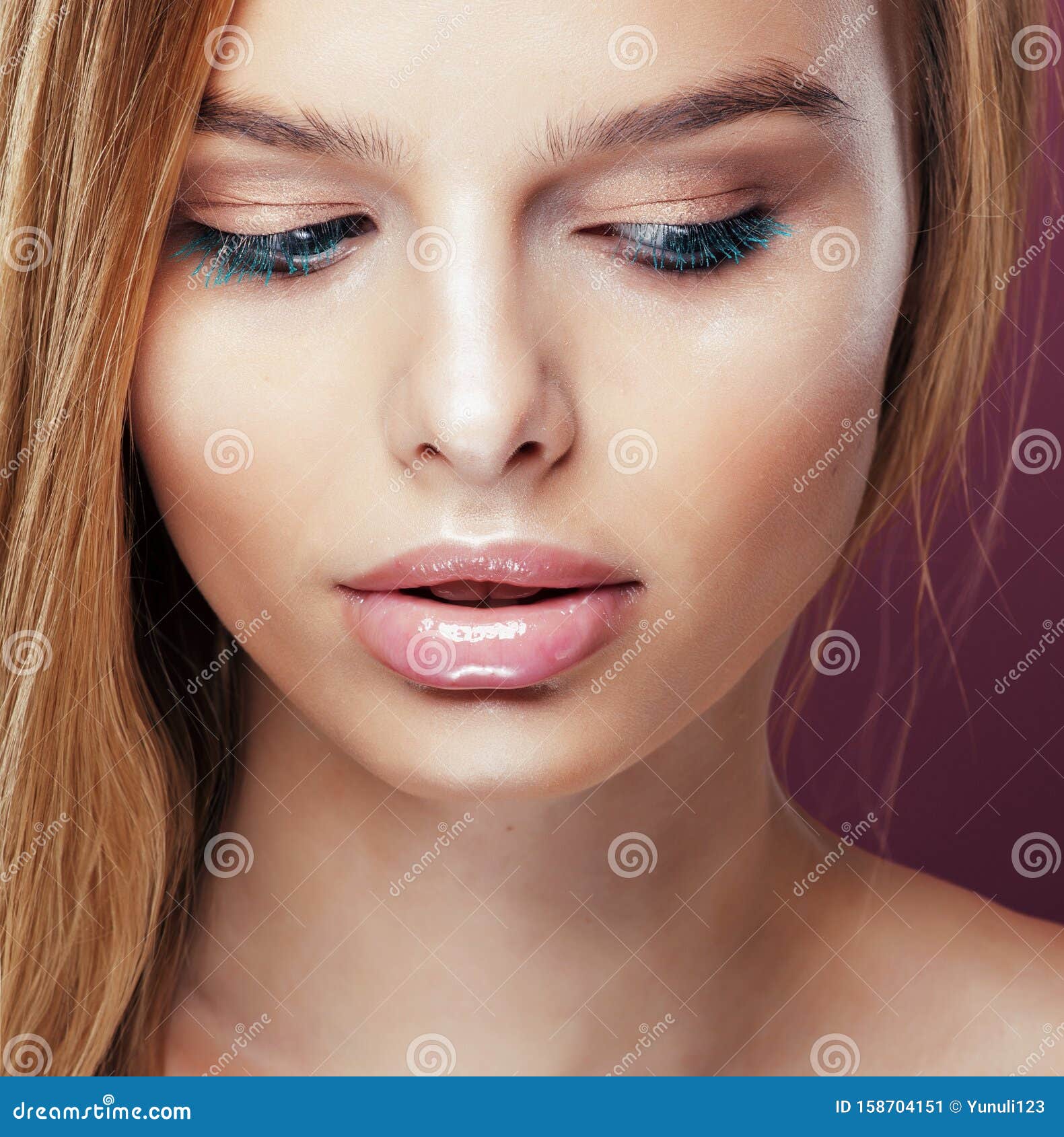 Young Pretty Blonde Woman With Hairstyle Close Up And Makeup On Pink