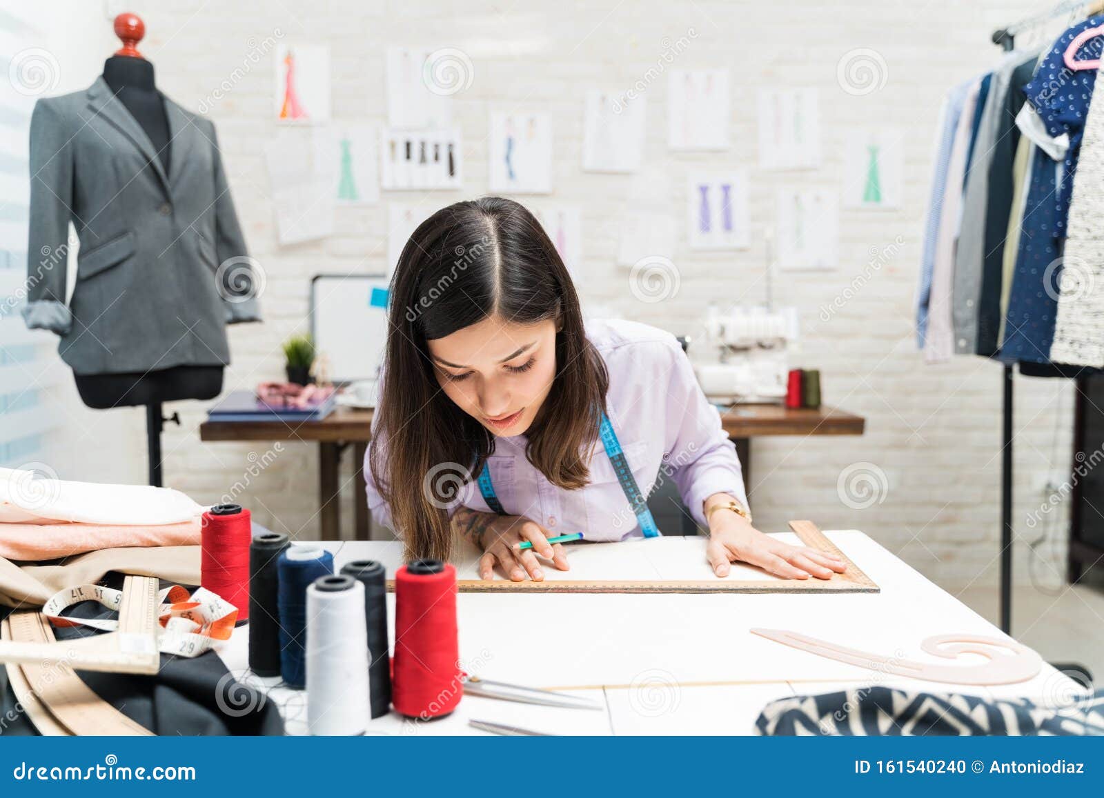 Young Pretty Dressmaker Drawing with Ruler at Atelier Stock Photo ...