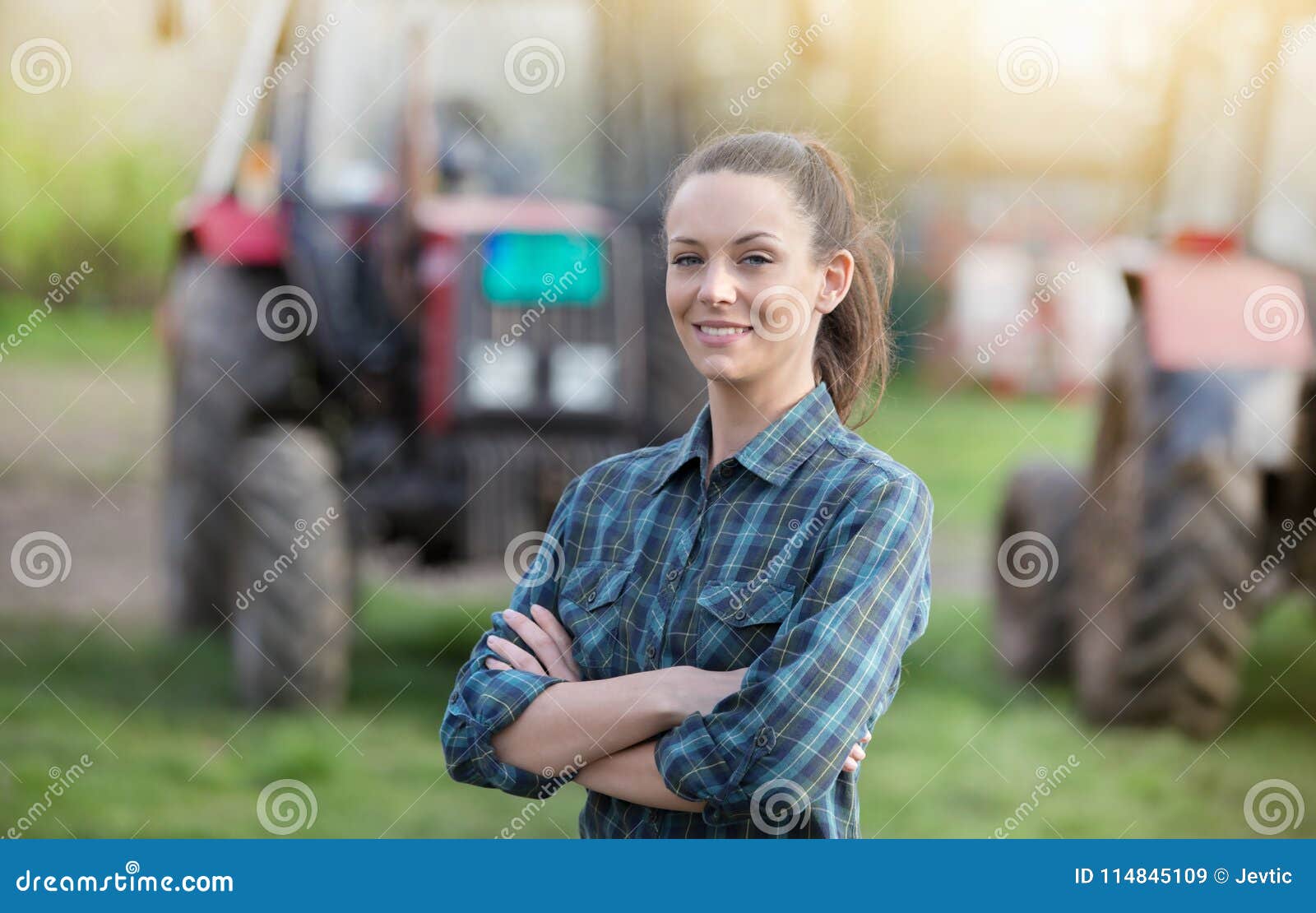 farmer woman with tractors on farmland