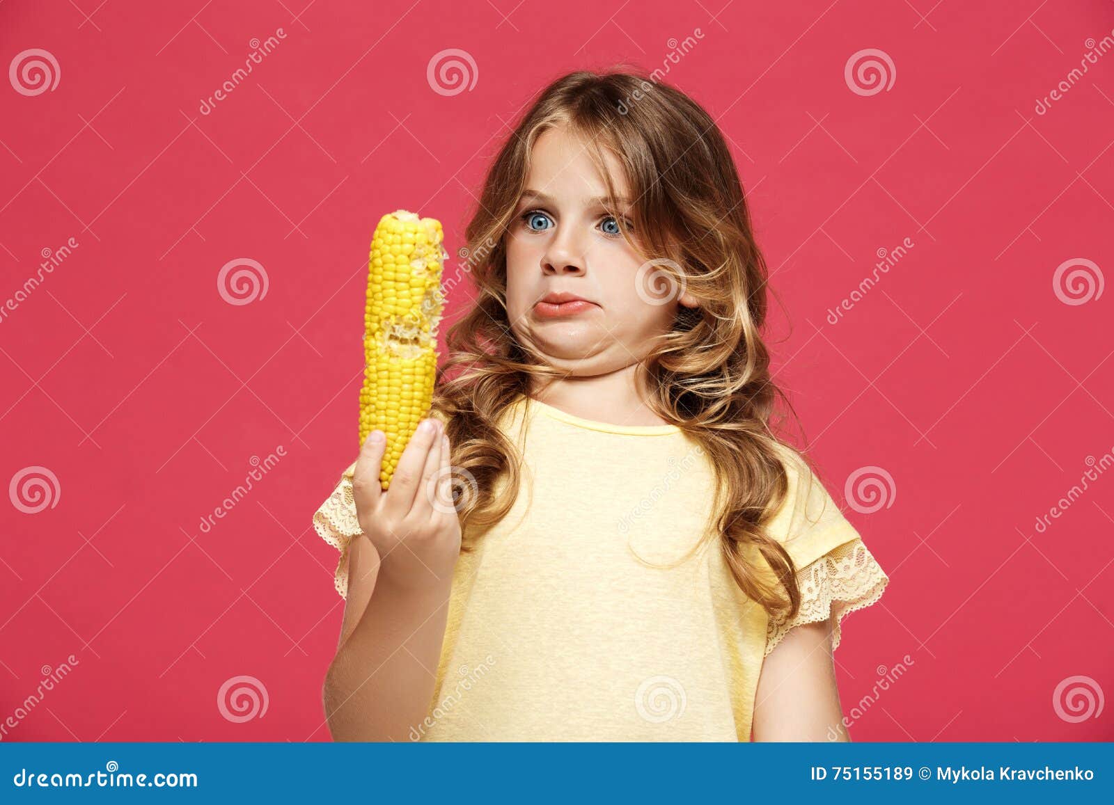 Young Pretty Girl Holding Corn Over Pink Background. Stock Image