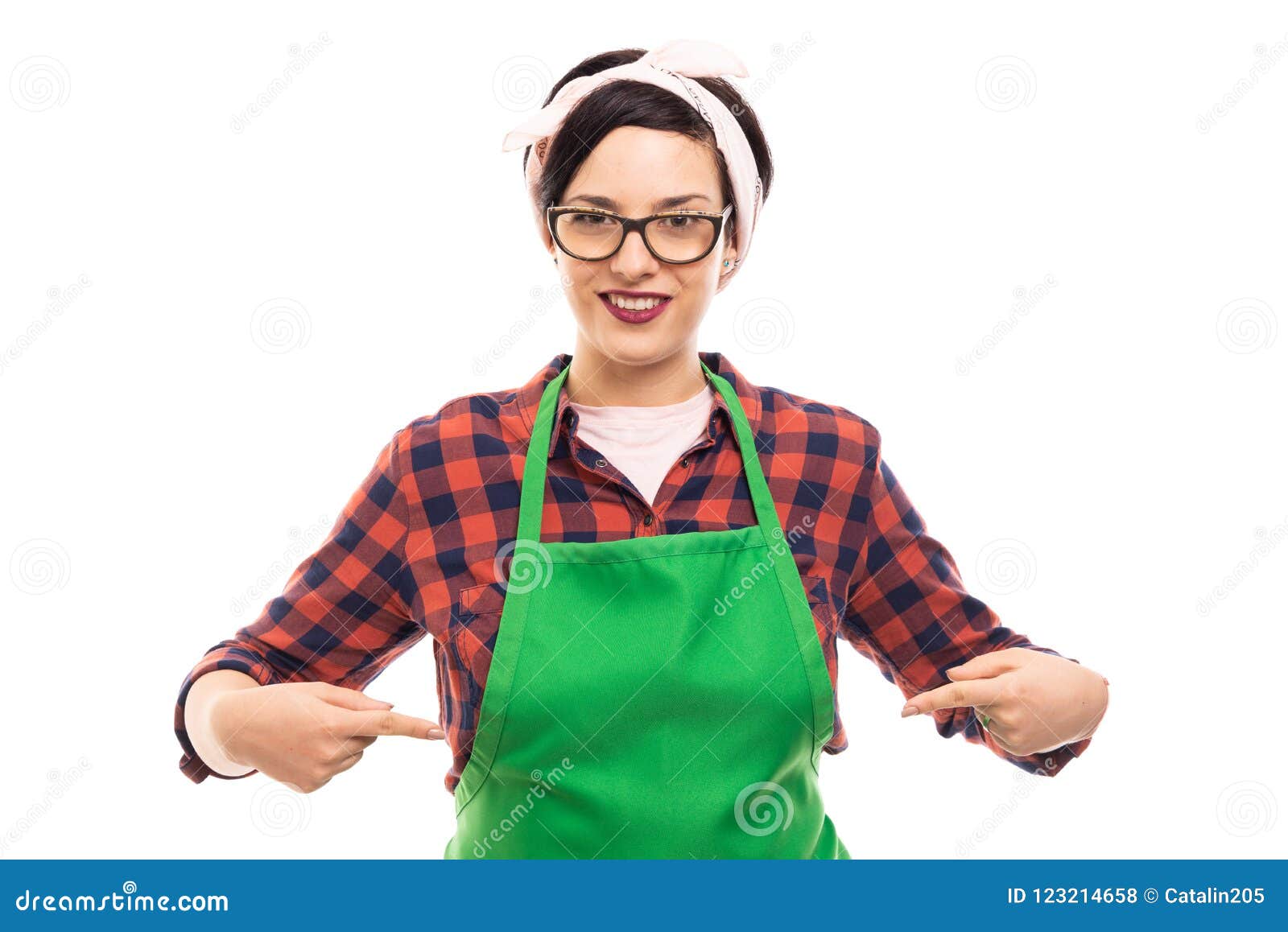 young pretty pin-up girl pointing fingers to green apron