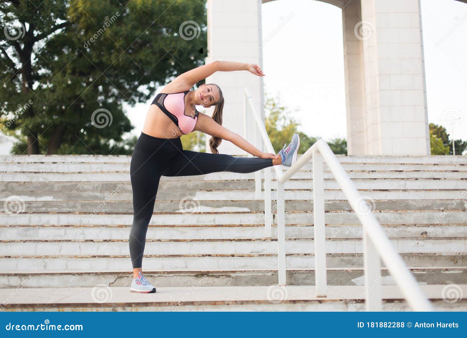 Young beautiful plus size woman in sporty top and leggings with