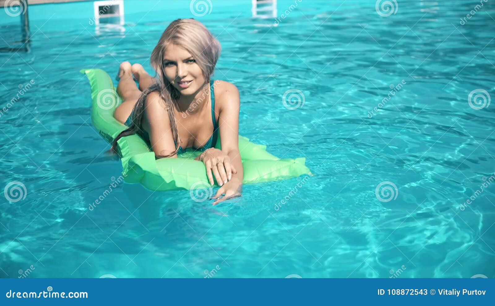 Young Pretty Woman Lying On Air Mattress In The Swimming Pool Stock
