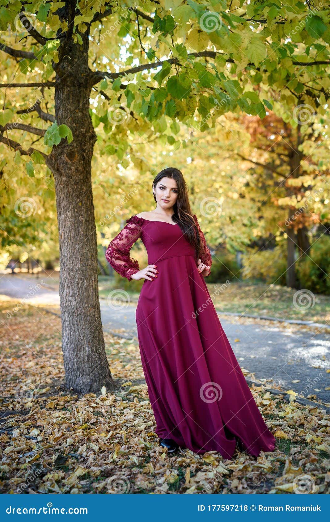 Young Princess in a Beautiful Red Dress in Park. the Background is ...