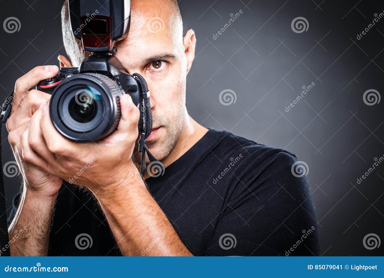 young, pro male photographer in his studio during a photo shoot