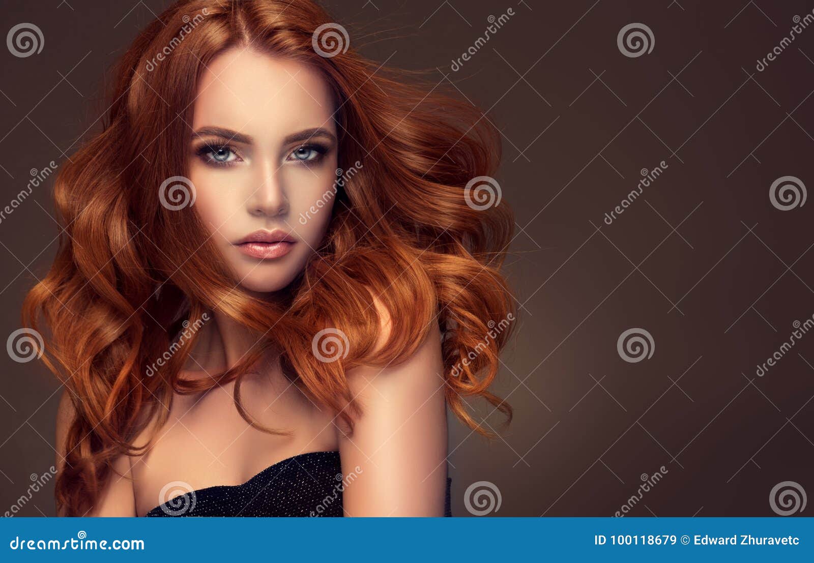 red haired woman with voluminous, shiny and curly hairstyle. flying hair.
