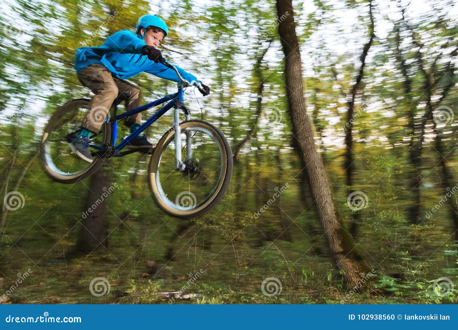 A Young Guy in a Helmet Flies Landed on a Bicycle after Jumping from a ...